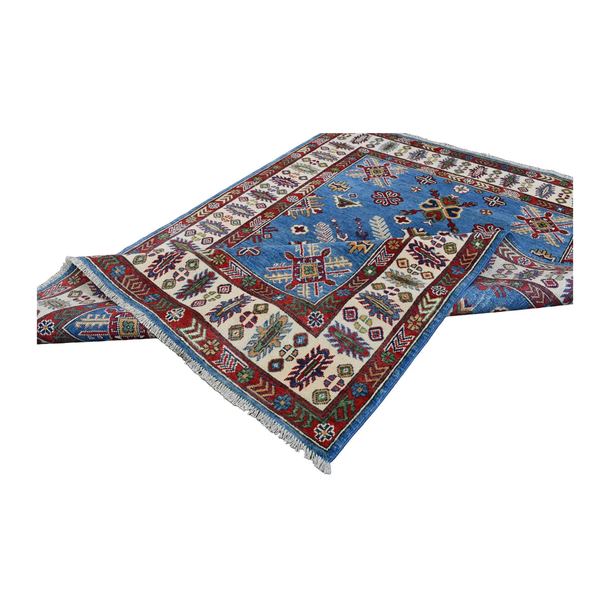 Folded view of Afghan Kazak hand-knotted wool rug showing its blue patterned field, ivory border and pale fringe