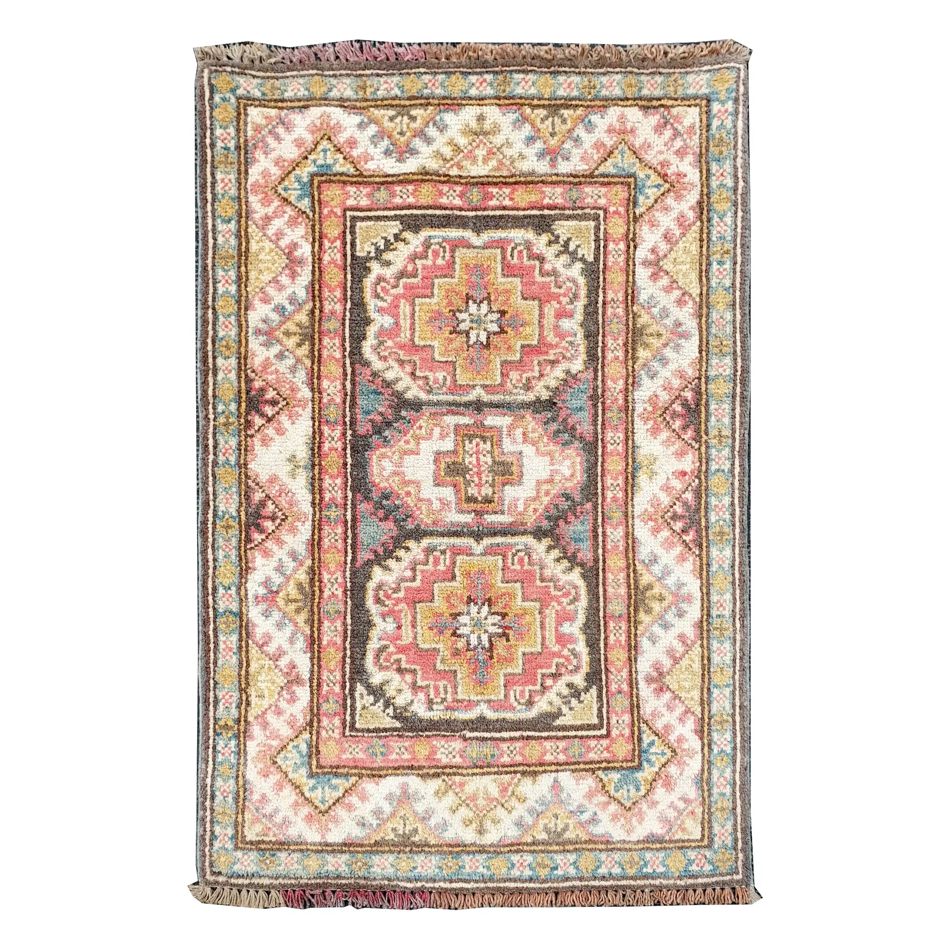 Full view of Afghan Kazak hand-knotted wool rug with cream field, muted red medallions and framed border, 86 x 61 cm