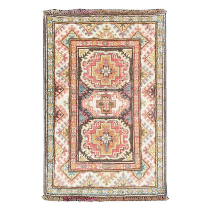 Full view of Afghan Kazak hand-knotted wool rug with cream field, muted red medallions and framed border, 86 x 61 cm