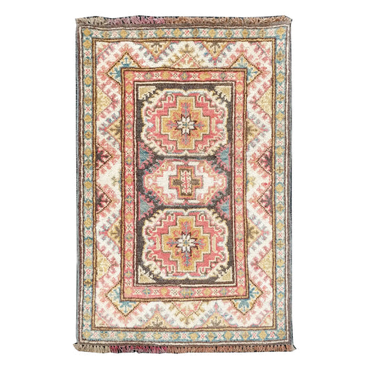 Full view of Afghan Kazak hand-knotted wool rug with cream field, muted red medallions and framed border, 86 x 61 cm