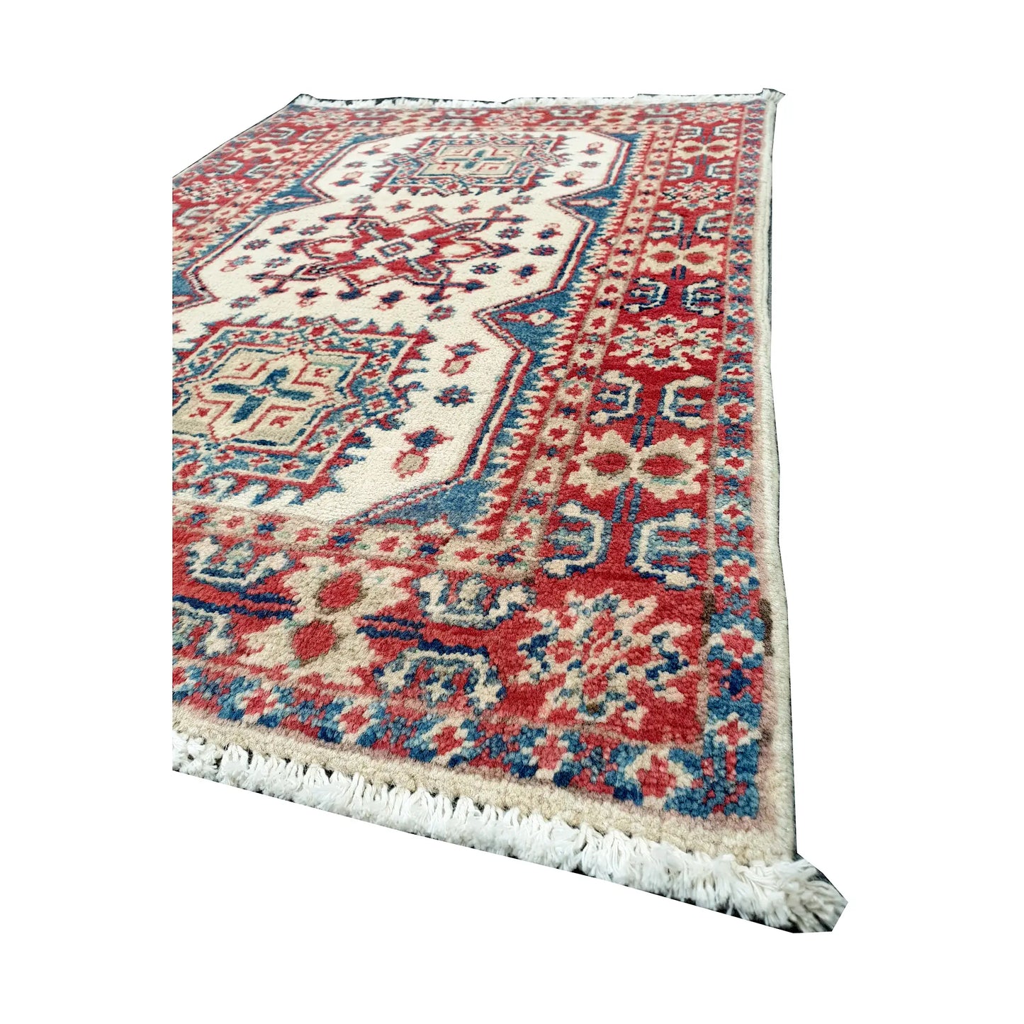 Angled corner and fringe view of Afghan Kazak wool rug showing cream field, muted red border detail, teal accents and light fringe