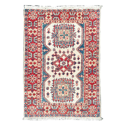 Full view of Afghan Kazak hand-knotted wool rug with cream field, muted red border, teal accents and geometric medallions, 86 x 62 cm