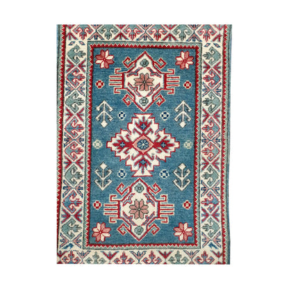 Front design view of Afghan Kazak hand-knotted wool rug showing blue field, central medallion, small motifs and framed border