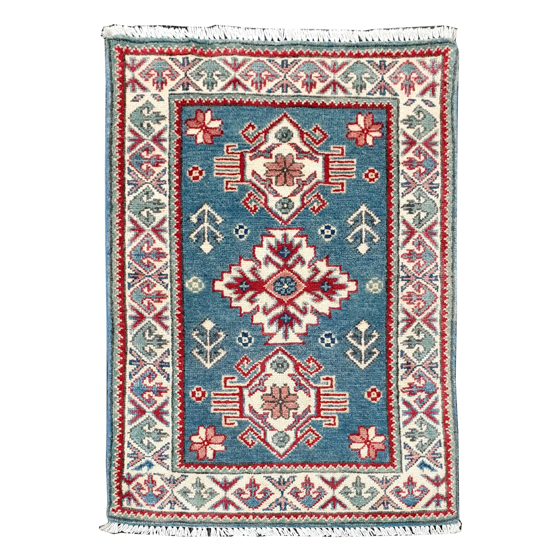 Full view of Afghan Kazak hand-knotted wool rug with blue field, central geometric medallion and cream patterned border, 90 x 61 cm