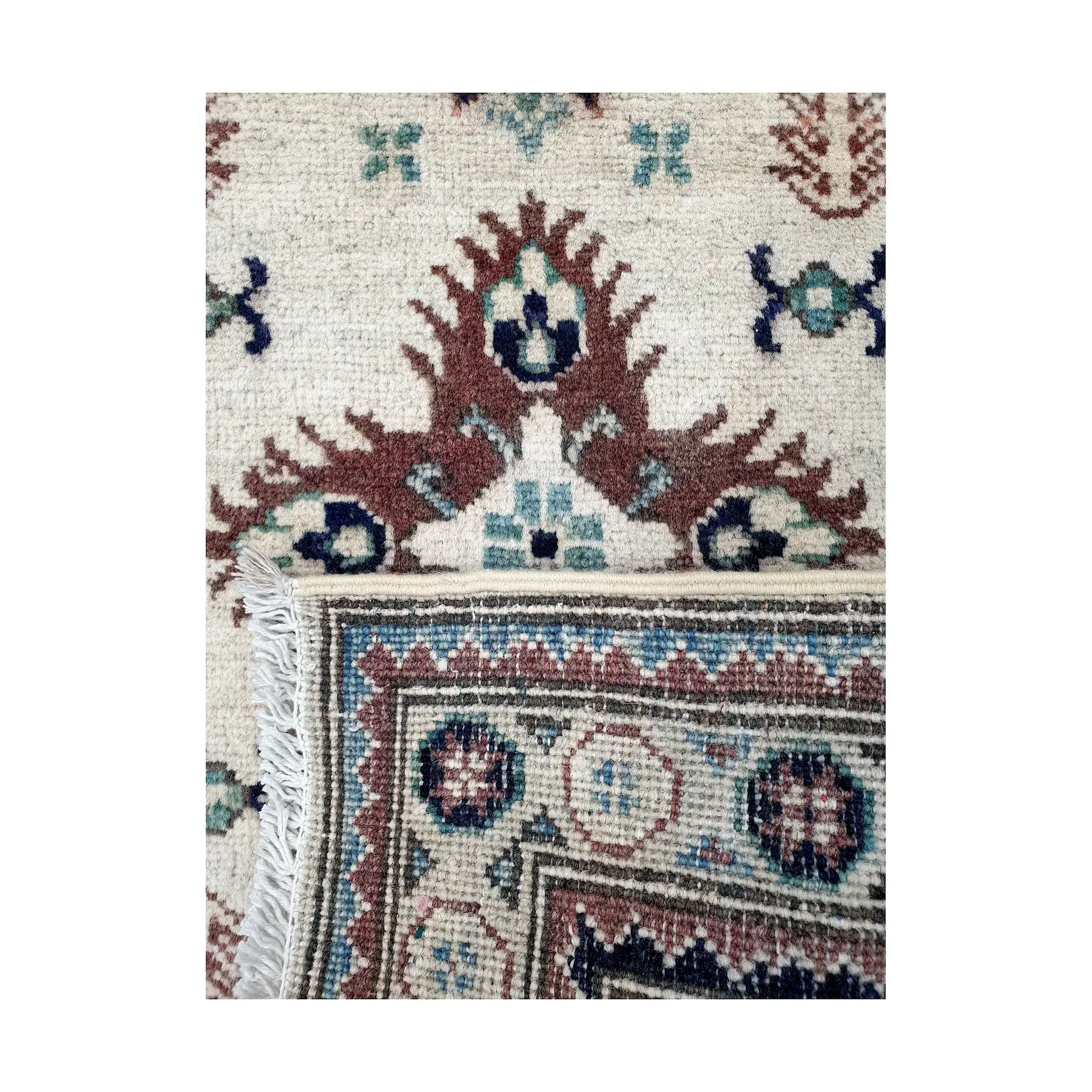 Folded corner reverse-weave detail of Afghan Kazak hand-knotted wool rug showing back structure, border pattern and woven detail