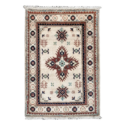 Full view of Afghan Kazak hand-knotted wool rug with ivory field, central geometric medallion and framed border, 90 x 64 cm
