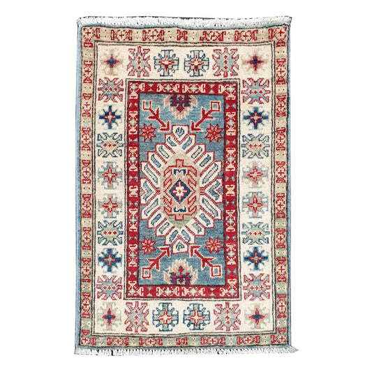 Full view of Afghan Kazak hand-knotted wool rug with blue field, off-white border and central geometric motif, 91 x 60 cm