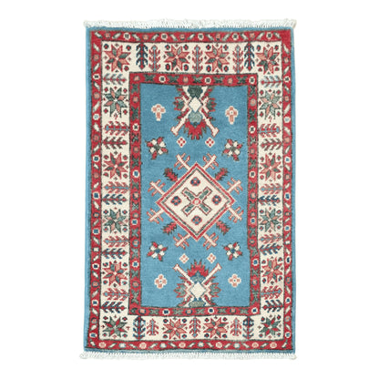 Full view of Afghan Kazak hand-knotted wool rug with blue field, central diamond medallion and red patterned border, 90 x 60 cm