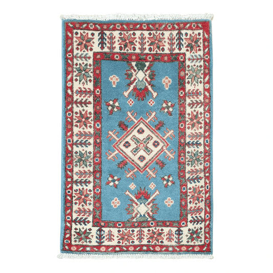 Full view of Afghan Kazak hand-knotted wool rug with blue field, central diamond medallion and red patterned border, 90 x 60 cm