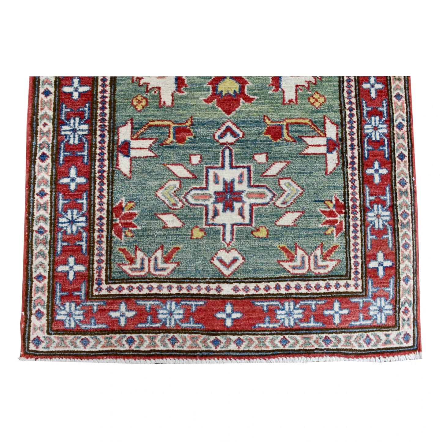 End-field detail of Kazak runner showing a cross-shaped medallion and layered red, ivory and pale-blue borders