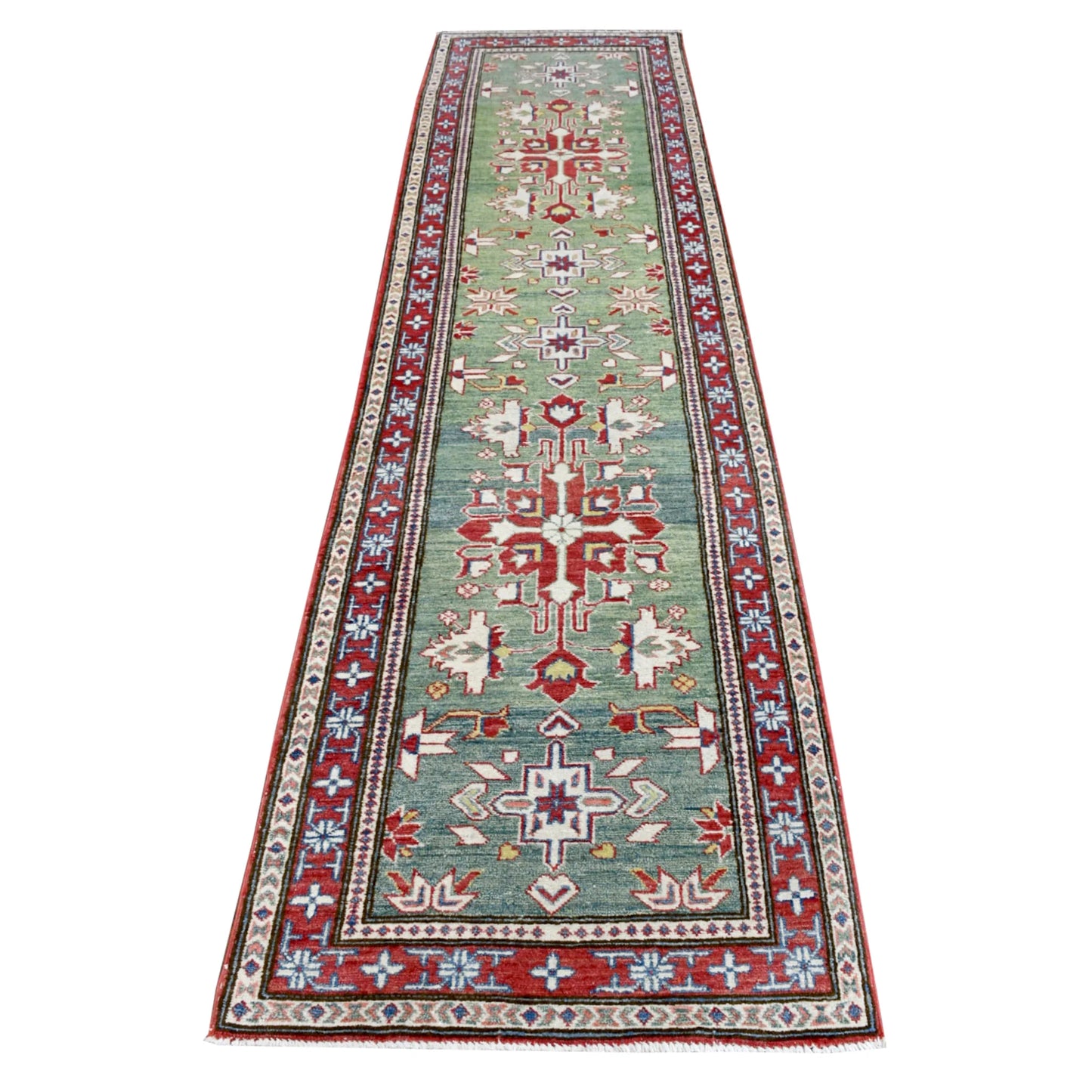 Full view of Afghan Kazak hand-knotted wool runner with a sage-green field, red geometric medallions and layered border, 327 x 83 cm