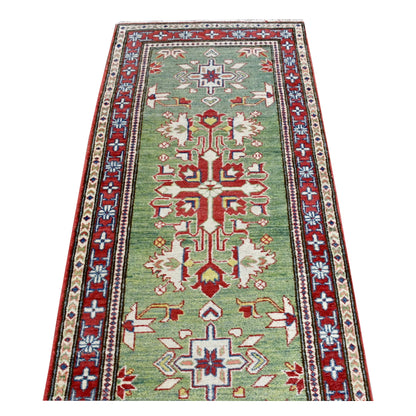 Lengthwise view of Afghan Kazak runner showing alternating red medallions and smaller cross motifs