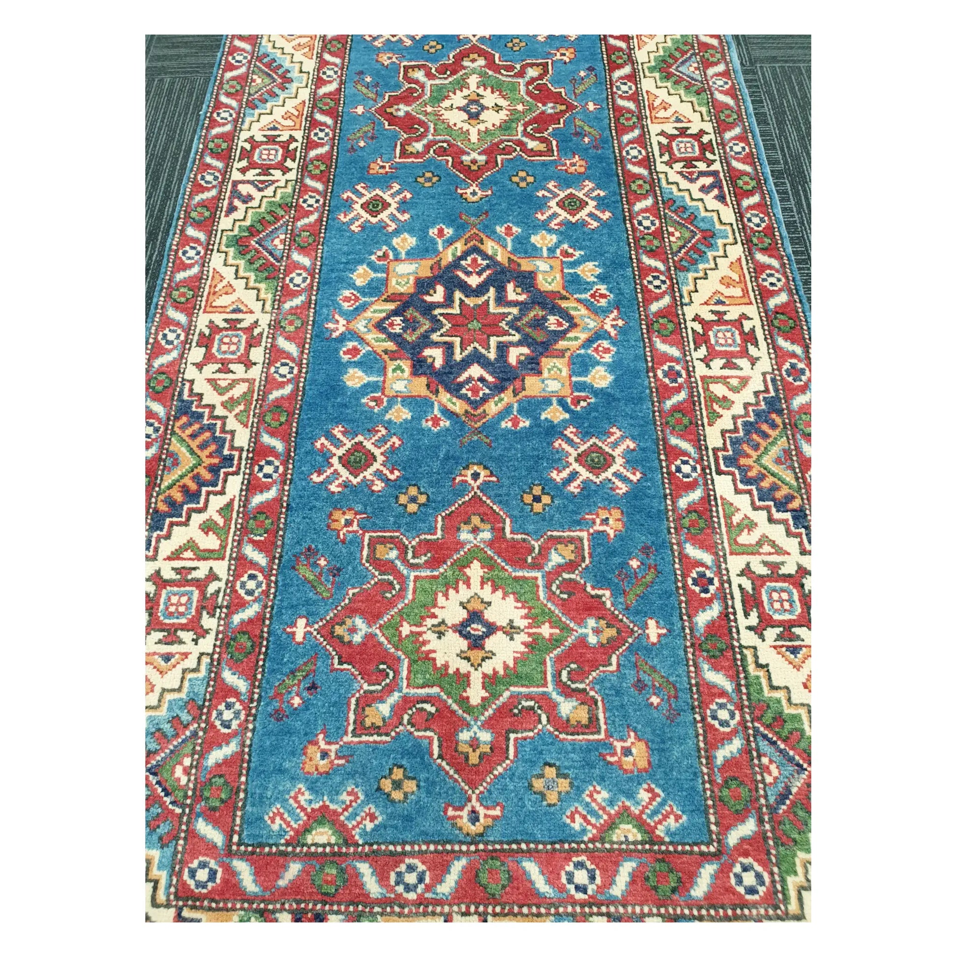 Close-up of Afghan Kazak runner with sky blue ground and multicolour geometric medallion pattern, 250 x 88 cm
