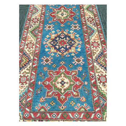 Close-up of Afghan Kazak runner with sky blue ground and multicolour geometric medallion pattern, 250 x 88 cm