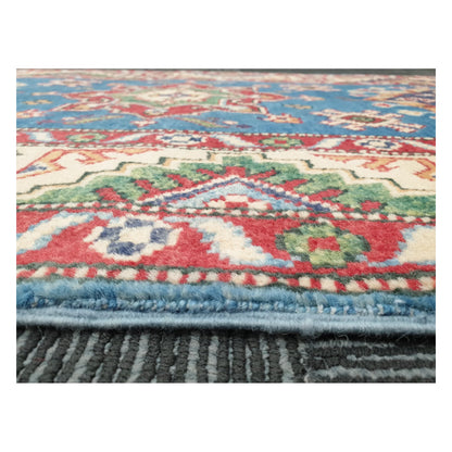 Low-angle close-up of Kazak runner showing wool pile texture and colourful tribal border detail, 250 x 88 cm