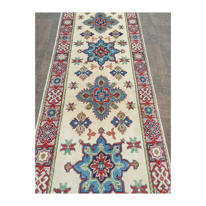 Medallion field detail of Afghan Kazak runner rug with red border and cream field