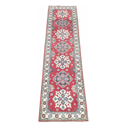Afghan Kazak hand-knotted wool runner rug 300 x 81 cm shown in full view with red geometric medallion design