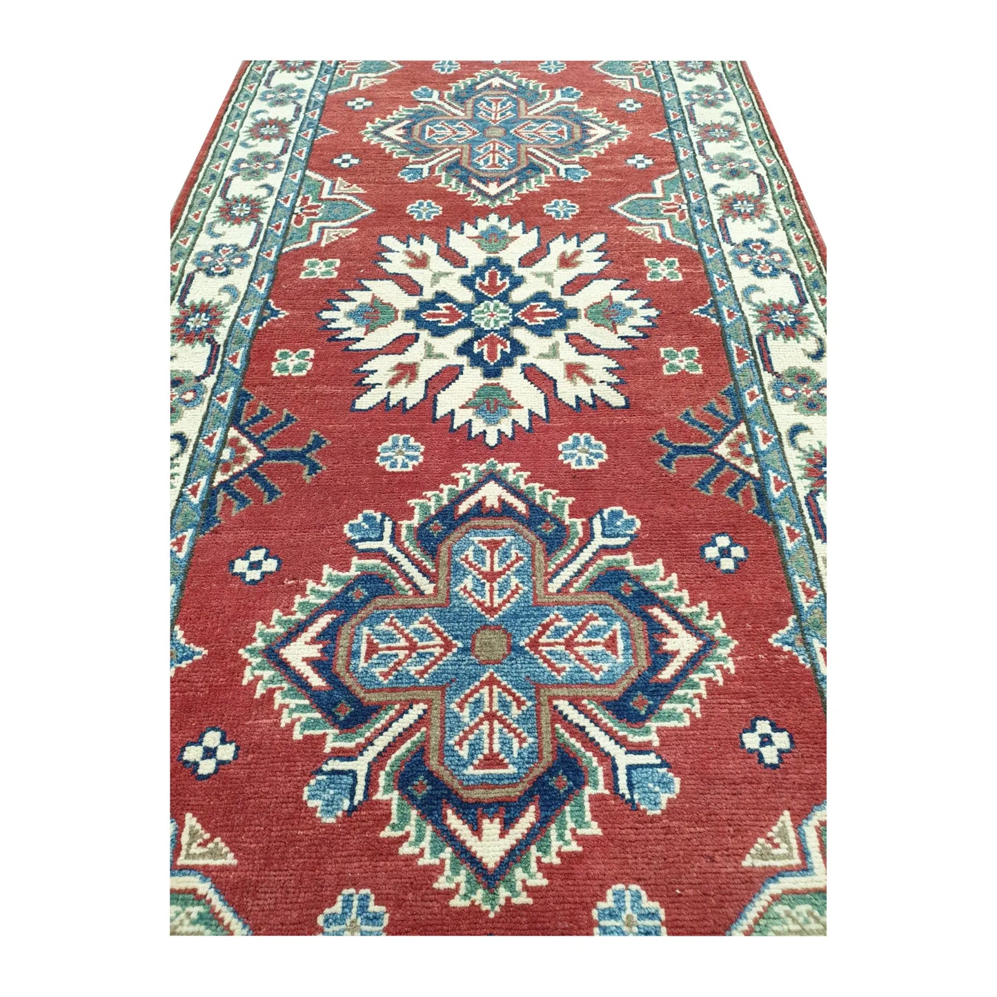 Close-up of Afghan Kazak runner rug medallion pattern with red, cream, blue and light green geometric detail