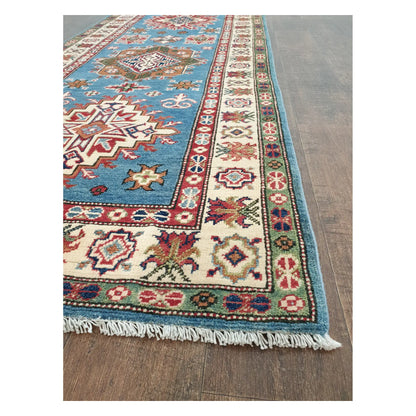 Angled detail of Kazak runner showing border motifs, fringe, and hand-knotted wool texture, 358 x 97 cm