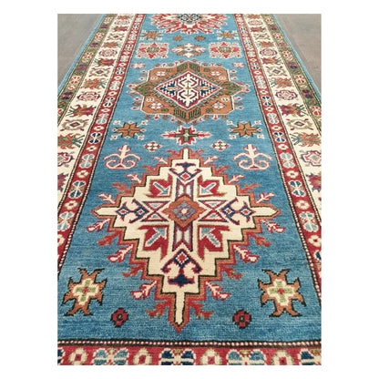 Close-up of Afghan Kazak runner with sky blue ground and multicolour geometric medallion pattern, 358 x 97 cm