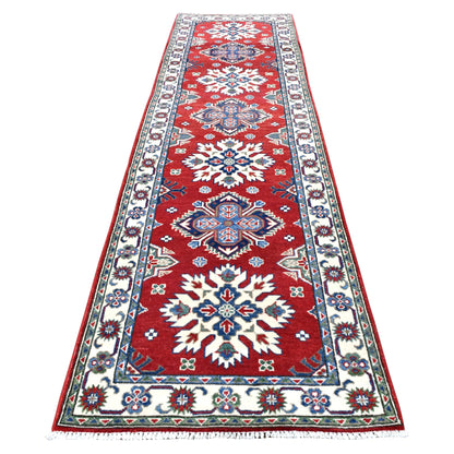 Full view of Afghan Kazak hand-knotted wool runner with red field, alternating ivory and blue medallions and floral border, 300 x 81 cm