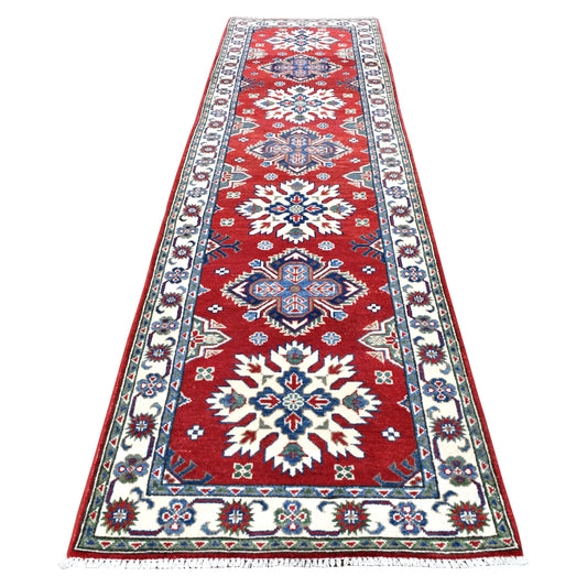 Full view of Afghan Kazak hand-knotted wool runner with red field, alternating ivory and blue medallions and floral border, 300 x 81 cm