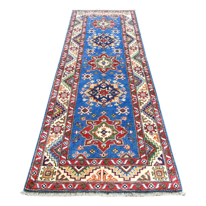 Full view of Afghan Kazak hand-knotted wool runner with blue field, red and navy geometric medallions and ivory border, 250 x 88 cm