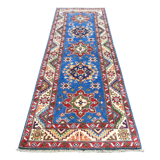 Full view of Afghan Kazak hand-knotted wool runner with blue field, red and navy geometric medallions and ivory border, 250 x 88 cm