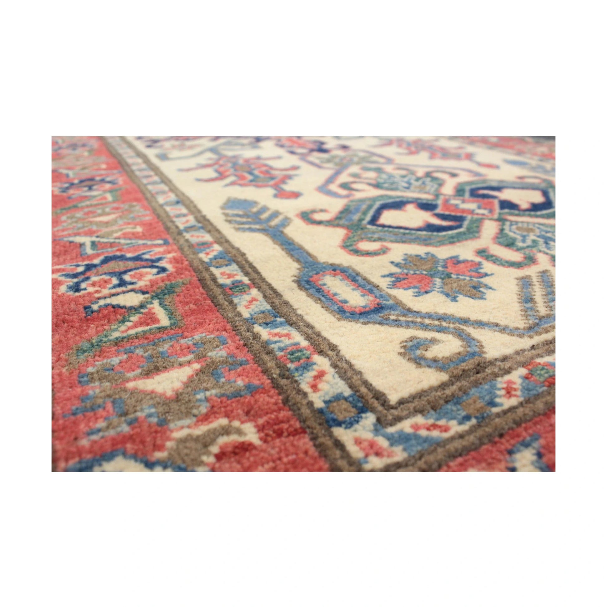 Angled view of Afghan Kazak wool runner rug with geometric motifs, 291 x 83 cm