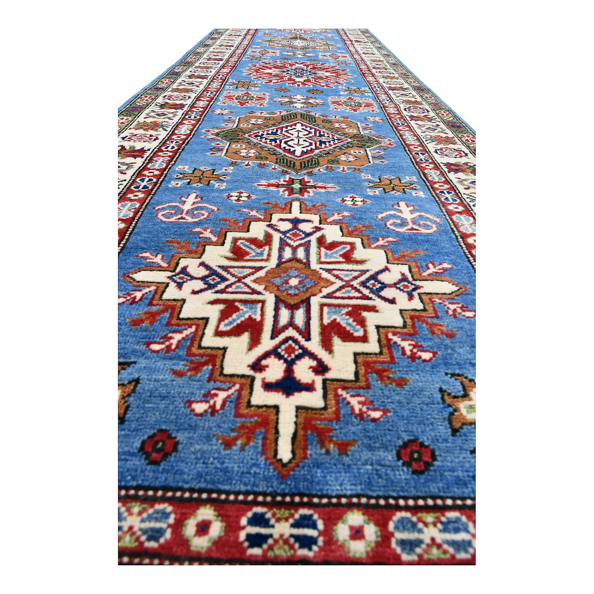 Angled close-up of Afghan Kazak runner showing a stepped star medallion and surrounding geometric motifs
