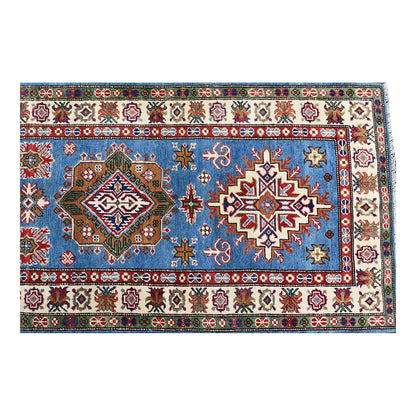 Overhead end section of Afghan Kazak runner showing polygonal medallions, small cross motifs and layered borders