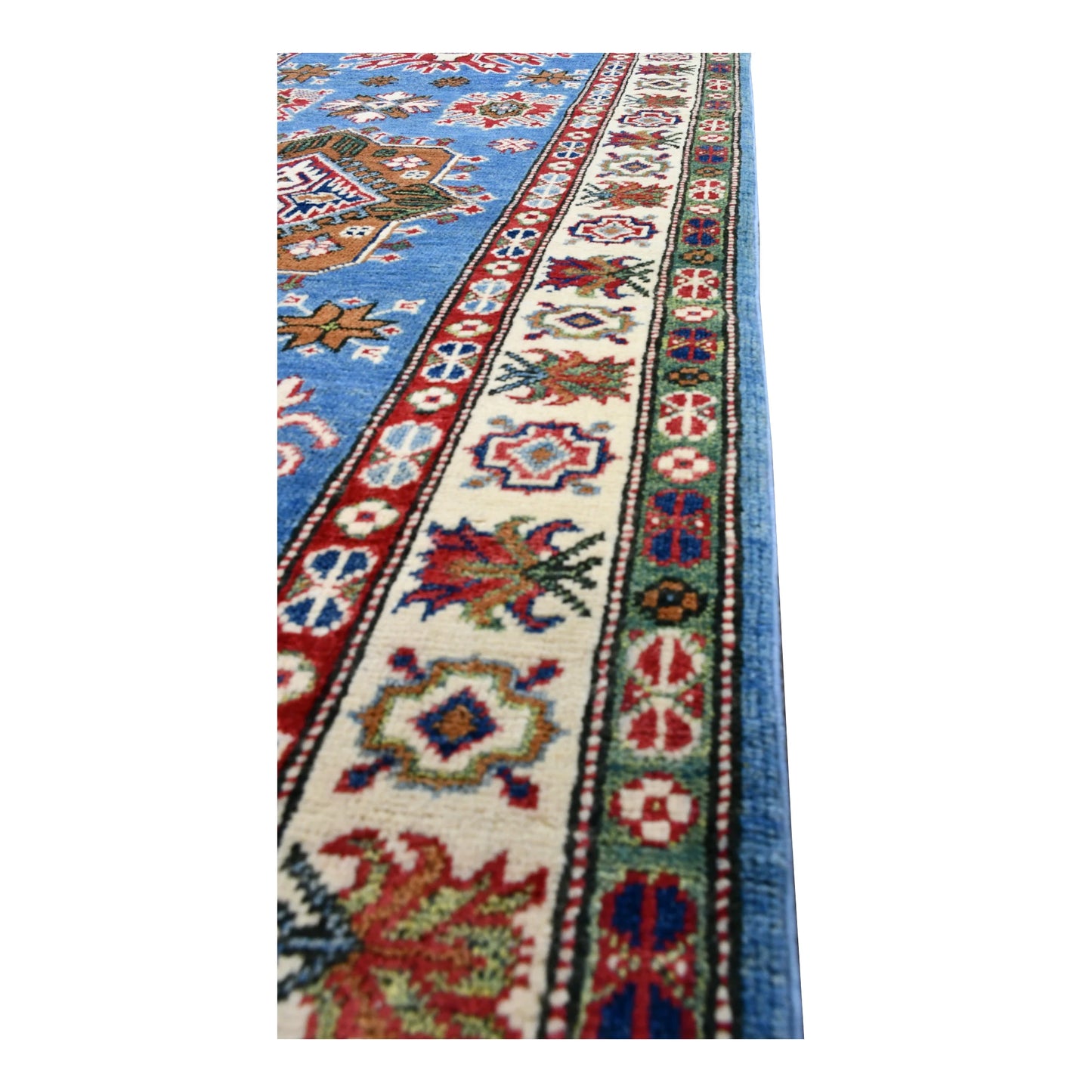 Side detail of Afghan Kazak runner showing the sky-blue field, red guard border and ivory floral-geometric border