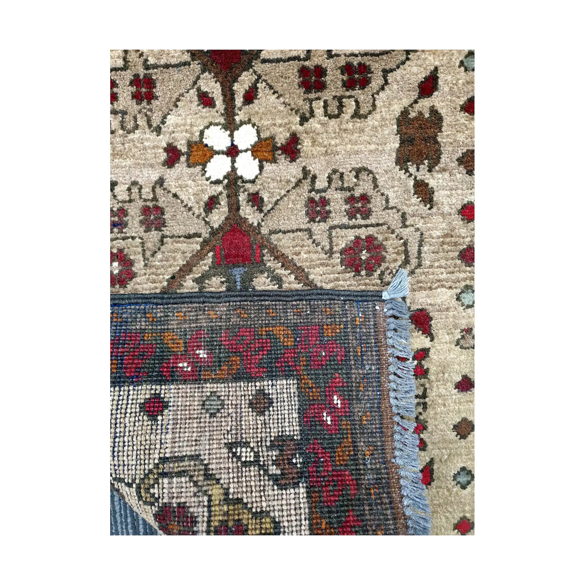 Folded corner reverse-weave detail of Afghan Khal Mohammadi hand-knotted wool rug showing back structure, fringe, border pattern and weave