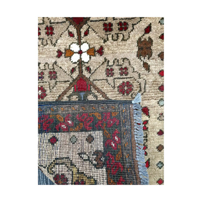 Folded corner reverse-weave detail of Afghan Khal Mohammadi hand-knotted wool rug showing back structure, fringe, border pattern and weave