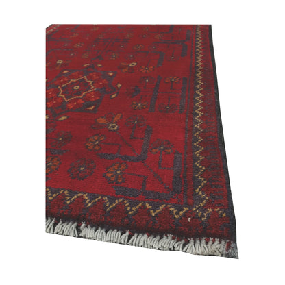 Angled corner and fringe view of Afghan Khal Mohammadi wool rug showing deep red field, dark border detail and light fringe
