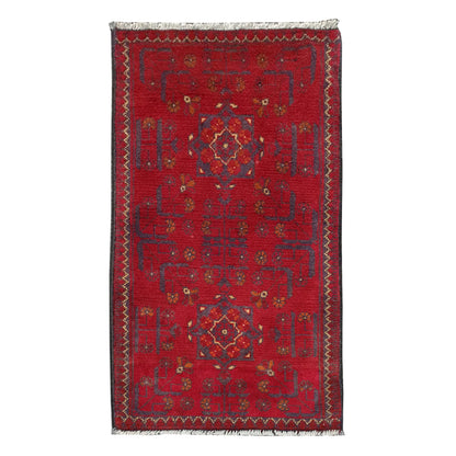 Full view of Afghan Khal Mohammadi hand-knotted wool rug with deep red field, central geometric medallion and patterned border, 102 x 52 cm