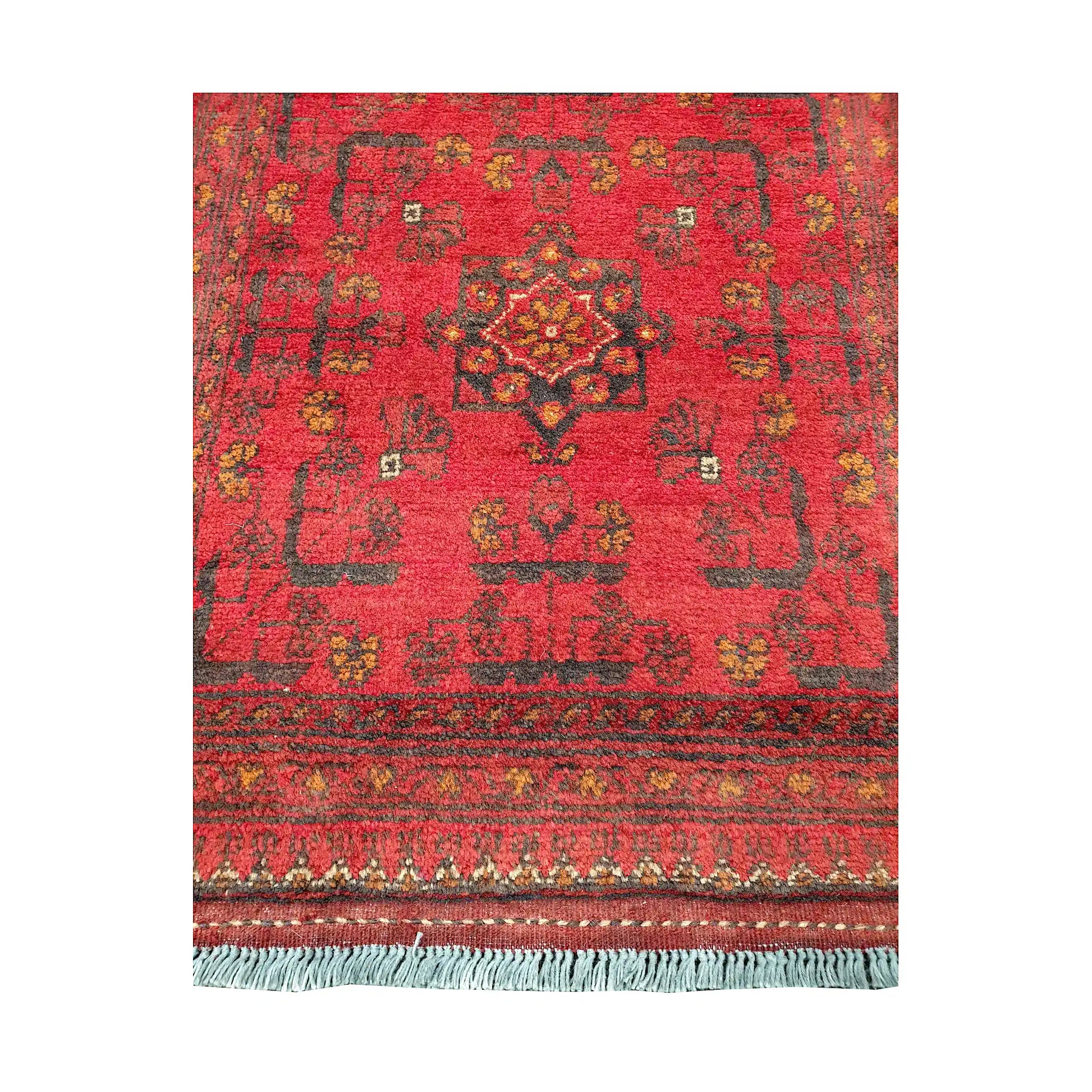 Central medallion and field detail of Afghan Khal Mohammadi hand-knotted rug showing red ground, small tribal motifs and patterned border