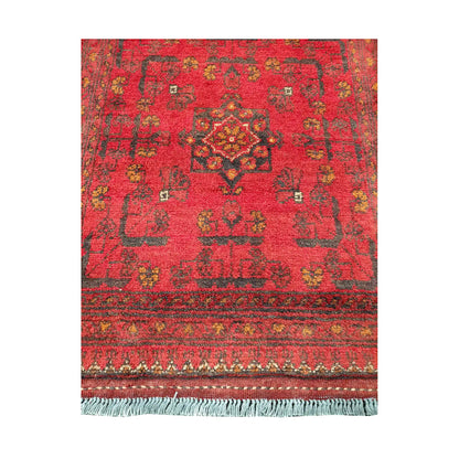Central medallion and field detail of Afghan Khal Mohammadi hand-knotted rug showing red ground, small tribal motifs and patterned border