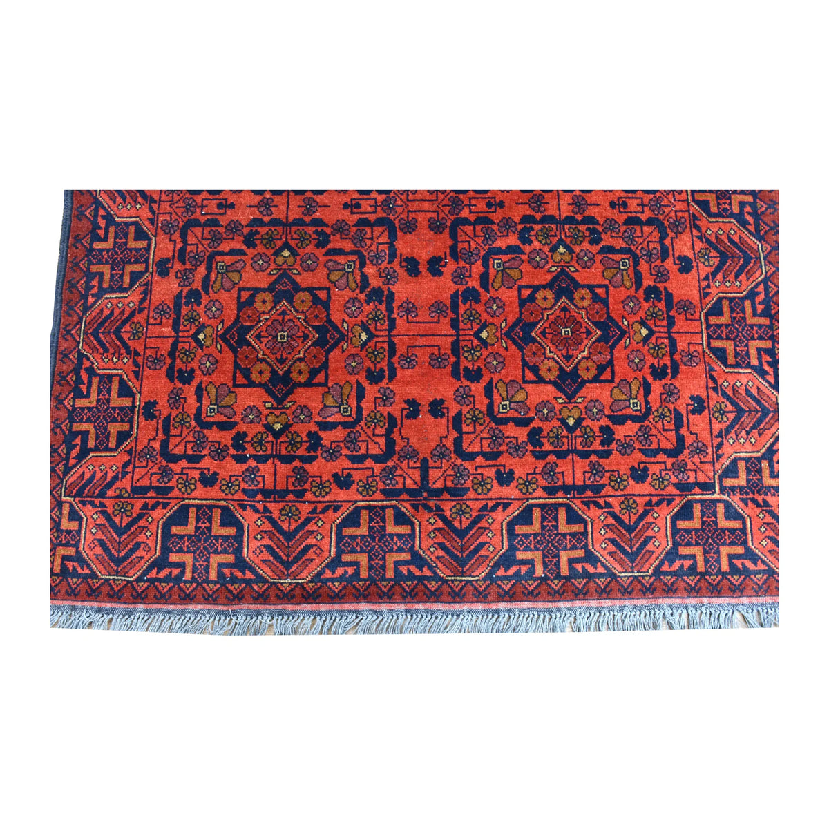 Fringe and end-border detail of Khal Mohammadi rug with paired geometric medallions and dark navy angular border