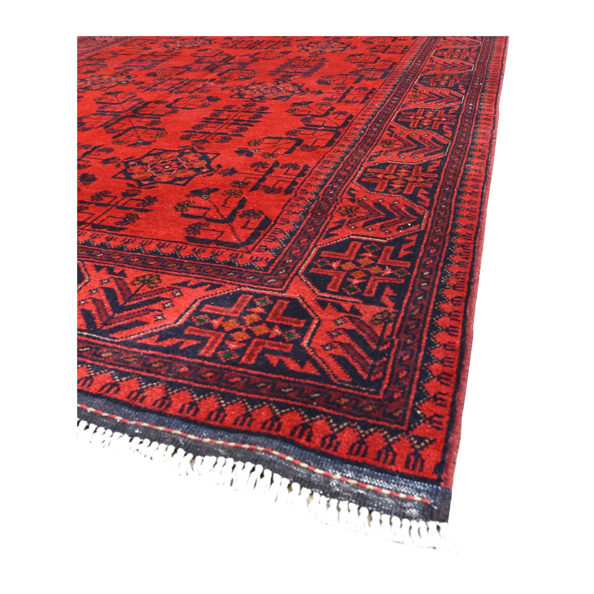 Angled view of Khal Mohammadi wool rug showing its rich red field, dark navy borders and pale fringe
