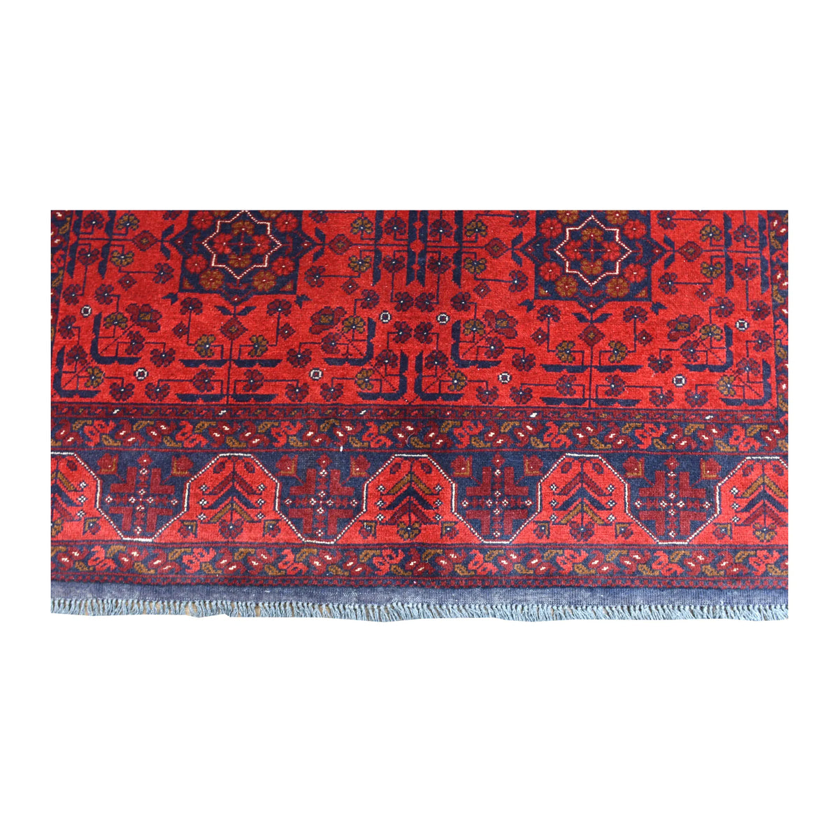 Fringe and end-border detail of Khal Mohammadi rug with angular red, dark navy and muted blue motifs