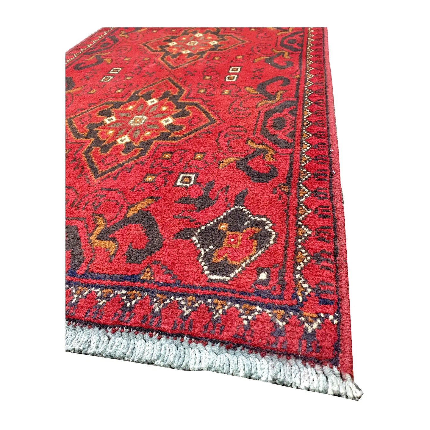 Angled corner and fringe view of Afghan Khal Mohammadi wool rug showing deep red field, dark border detail and light fringe