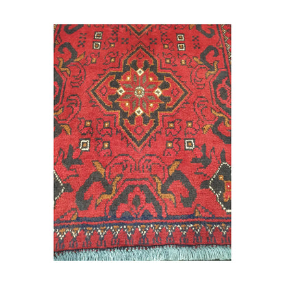 Central medallion and field detail of Afghan Khal Mohammadi hand-knotted rug showing red ground, dark motifs and geometric border