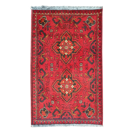 Full view of Afghan Khal Mohammadi hand-knotted wool rug with deep red field, central geometric medallion and patterned border, 97 x 52 cm