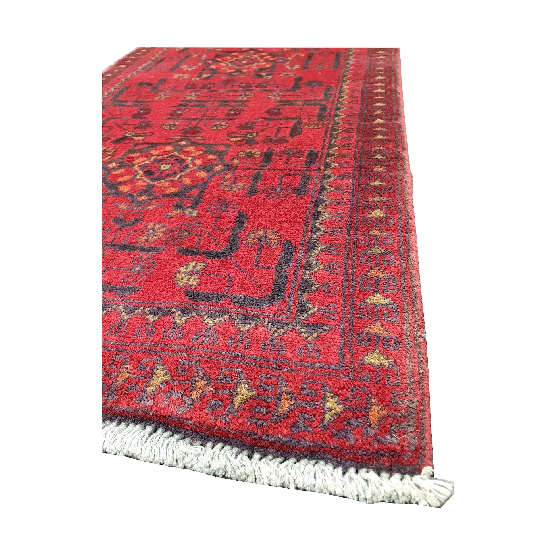 Angled corner and fringe view of Afghan Khal Mohammadi wool rug showing deep red field, dark border detail and light fringe