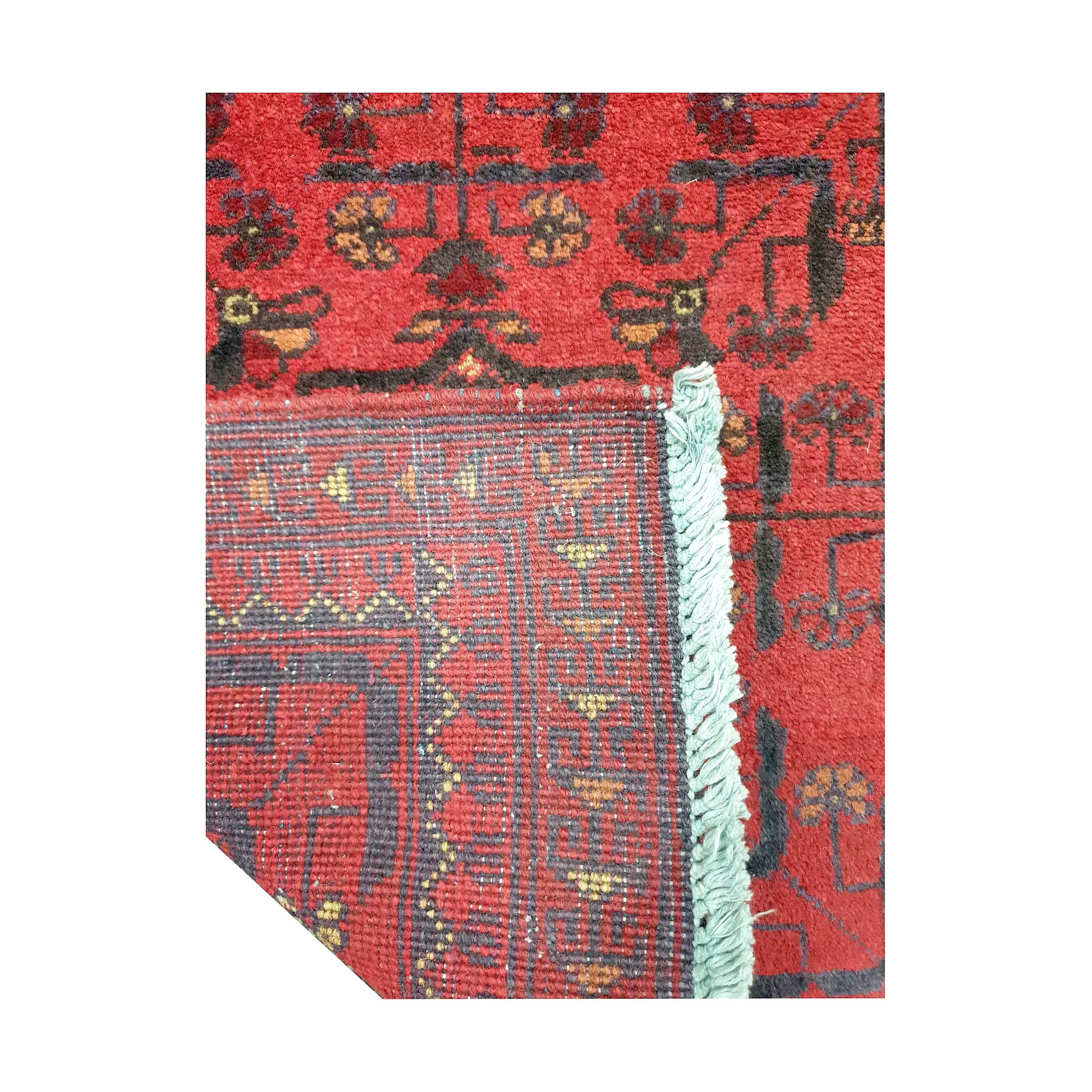 Folded corner reverse-weave detail of Afghan Khal Mohammadi hand-knotted wool rug showing back structure, red field, border pattern and weave