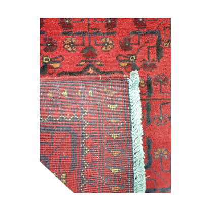 Folded corner reverse-weave detail of Afghan Khal Mohammadi hand-knotted wool rug showing back structure, red field, border pattern and weave