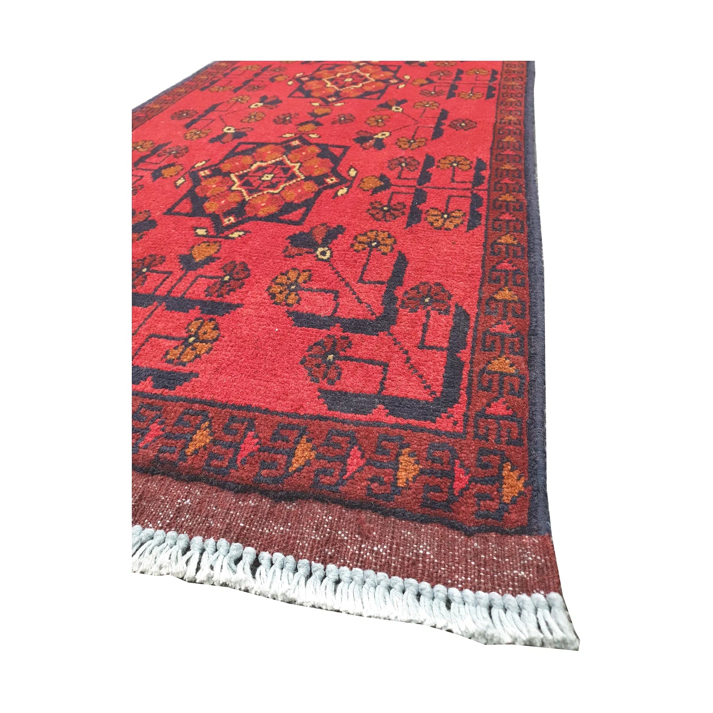 Angled corner and fringe view of Afghan Khal Mohammadi wool rug showing deep red field, dark geometric motifs and light fringe