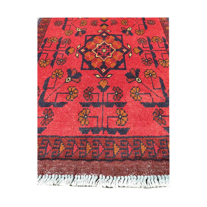 Central medallion and field detail of Afghan Khal Mohammadi hand-knotted rug showing red ground, dark motifs and patterned border