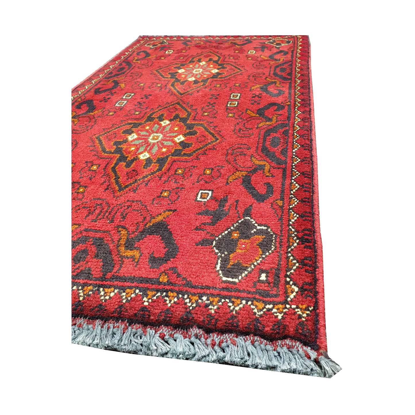 Angled corner and fringe view of Afghan Khal Mohammadi wool rug showing red field, dark border detail and light fringe